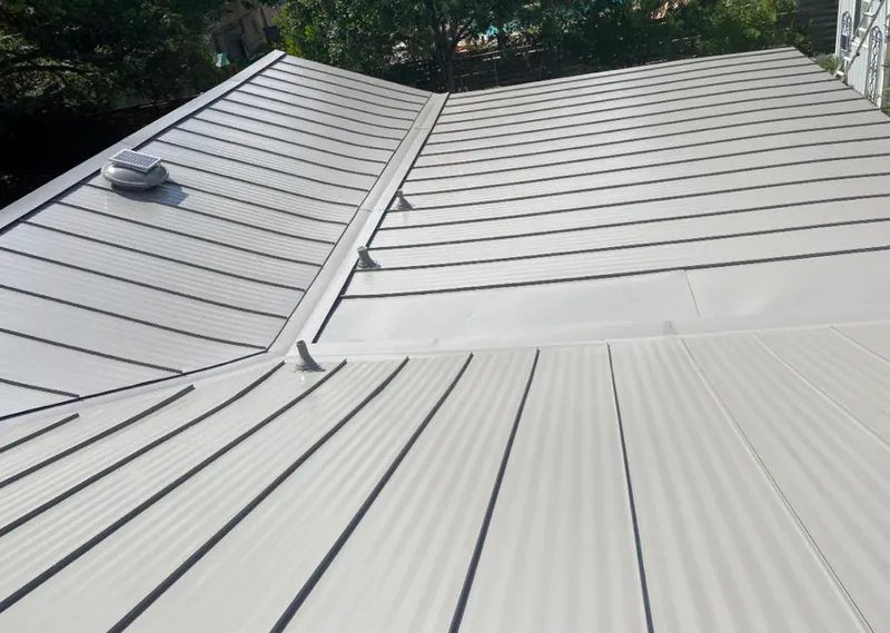 Solar attic fan installed on a metal roof for Roof Ventilation in Albuquerque